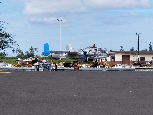 North American TB-25 Mitchell (N7946C) - "Old Glory," a B-25J sits on a barge, awaiting loading onto the USS Essex for her trip back to the Mainland from O'ahu. Somewhere, Jimmy Doolittle, Dick Cole and the other 78 Raiders are smiling down at this.