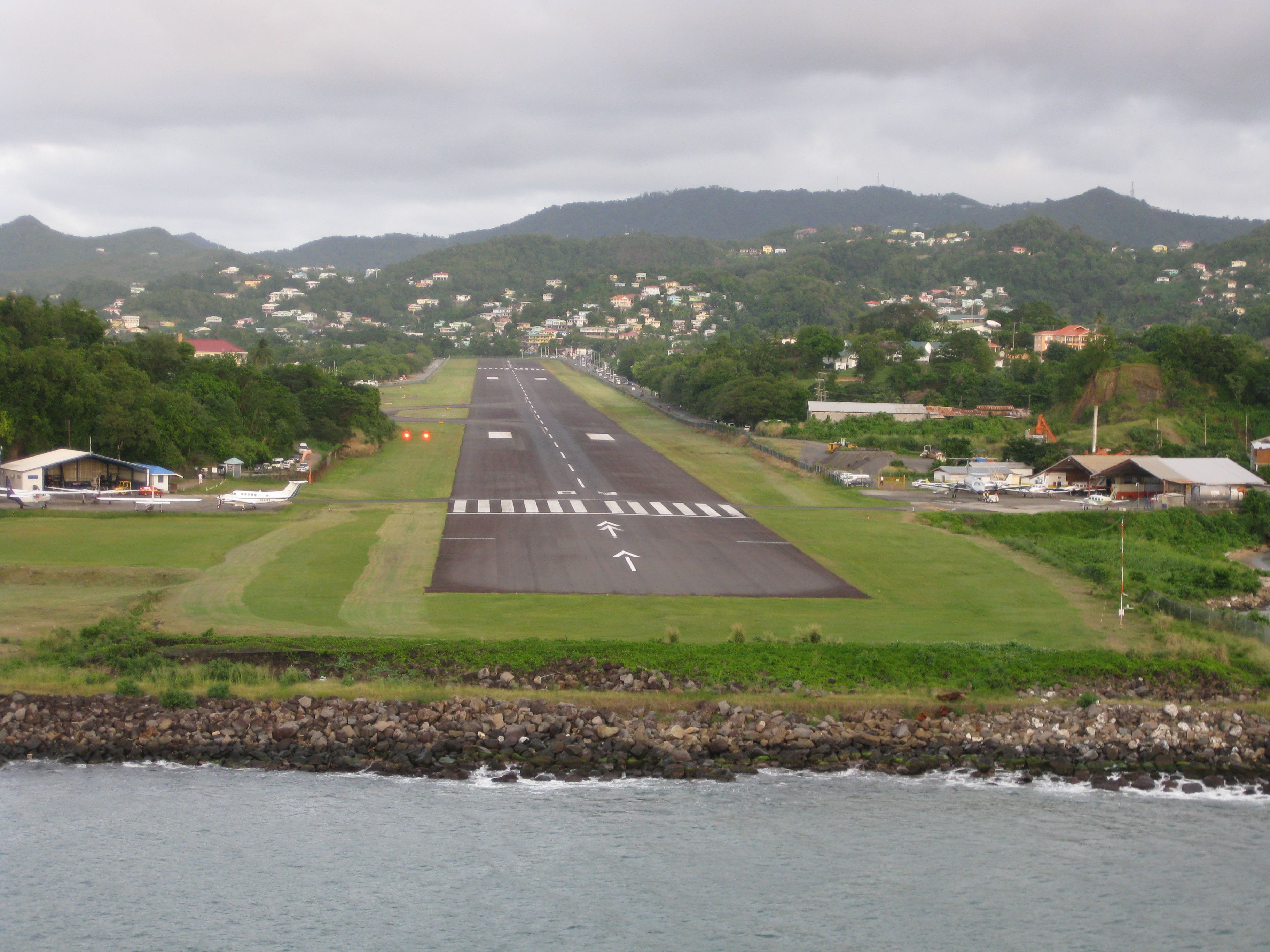 — — - George F. L. Charles Airport, formerly Vigie Airport.(IATA: SLU,ICAO:TLPC) is the smaller of two airports in Saint Lucia, the other being Hewanorra International Airport. It is located 2 km north of Castries, the capital city.    Picture taken from aboard a cruise ship as it left Castries