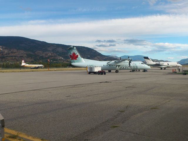 C-FVFH — - Penticton CYYF Canada - DC6 Electra tanker taxi to 34. Dash-8 and Challenger in foreground