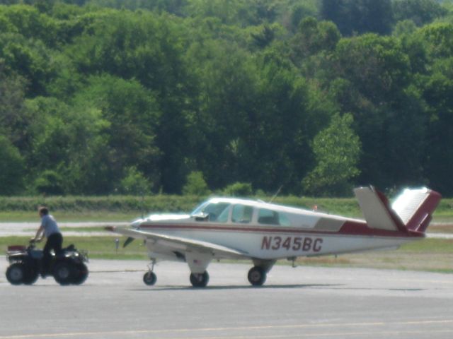 Beechcraft 35 Bonanza (N345BC) - Getting towed to its tiedown after some maintenance.