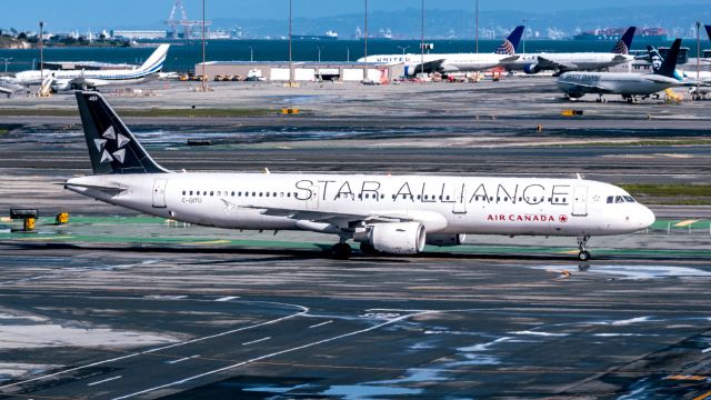 Airbus A321 (C-GITU) - Air Canada A321 with the Star Alliance livery taxis past SkyTerrace at KSF following some light showers in the area.