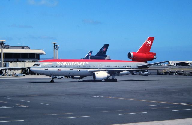 McDonnell Douglas DC-10 (N133JC) - PHNL - July 1998 - NWA DC-10 on a slow taxi arriving at the gate. PHNL had one of the busiest  cargo ramps Ive ever seen - most of my 1998 HNL photos have at least 1-ramp kart jammin through the view. This was an excellent airport to film at. We had a Tower Tour scheduled for 1pm so we cruised the terminals and upper parking garage from sun up - the Tower Tour, back to the Terminals until my 13 yr old about had it...so we went back to the high rise on Kaluakala Blvd to rest!