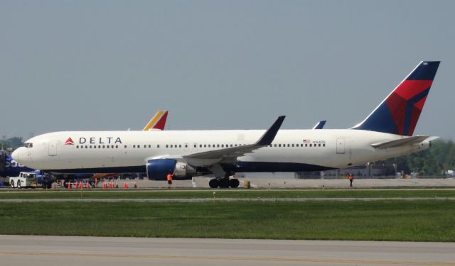 BOEING 767-300 (N184DN) - DIVERSION!! This 767-300 was supposed to be going from JFK-ANC but diverted to BUF for an electrical issue. The plane stayed overnight and departed the next day. Such a cool sight; seeing heavies divert to smaller airports like BUF! (pushback shot)