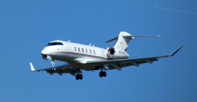 Canadair Challenger 350 (N744QS) - On final is this 2017 Bombardier Canadair Challenger 350 in the Autumn of 2020. That contrail is an American Boeing 777 enroute London to Charlotte. 