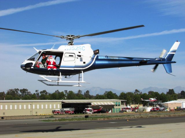 Eurocopter EC-635 (N352SC) - Santa lifting off from Fullerton Airport