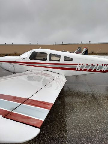 Piper Cherokee (N777CW) - Parked at KREI during rain storm - free shower.