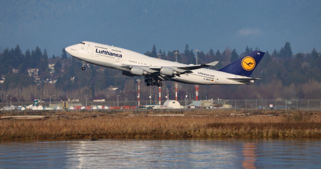 Boeing 747-400 (D-ABVU) - Lufthansa Boeing 747-430 D-ABVU departure at YVR for FRA with a bonus reflection off the Fraser River. Taken from the Terra Nova Park area, Richmond, BC. 