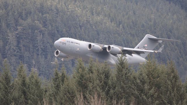 Boeing Globemaster III (N70045) - New York Air National Guard C-17 70045 climbing out of Juneau, departing to the west.  The four engined C-17 is much quieter than the twin engine 737s we normally  see here!