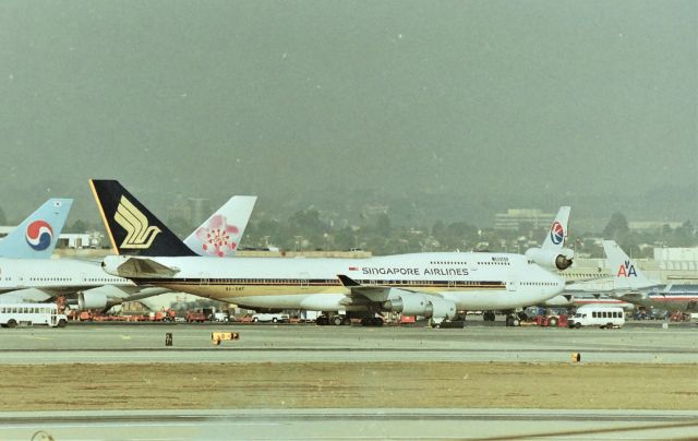 Boeing 747-400 (9V-SMH) - KLAX - "Megatop" arriving at the Tom Bradley Intl terminal Jan 1998 - photo from Imperial Hill 60-300mm. Watching the hourly 'shuffling" of jets at TBT was always fun.