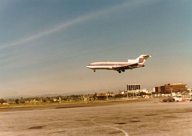 Boeing 727-100 — - United B-727 landing at KLAX spring 1977. Note the FLY WESTERN on the building in the background