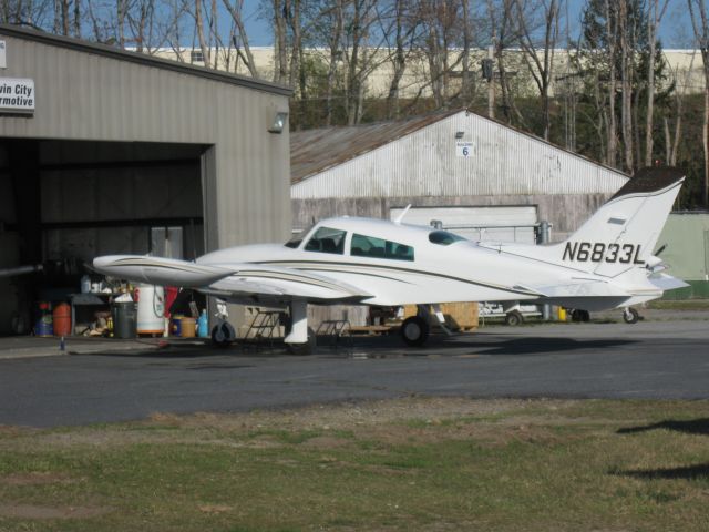 Cessna 310 (N6833L) - Getting maintenance done at Twin City Airmotive. This photo shows her with a new paint job.