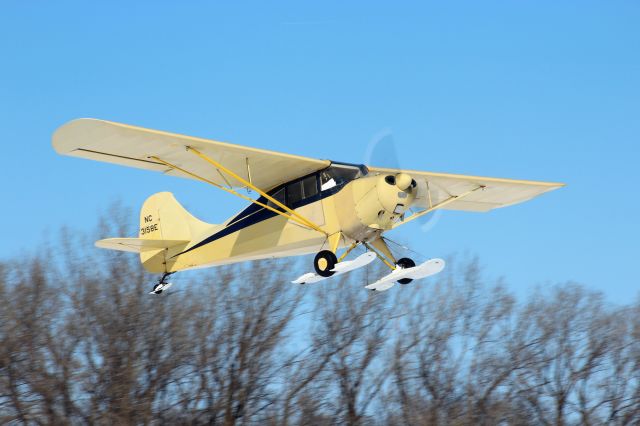 NC3158E — - Climbing in to the clear blue sky at Oshkosh after a ski take-off.  