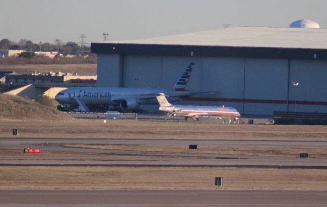 BOEING 777-300ER (N718AN) - 013013 AA N718AN at hanger east of the terminal prior to the first flight ar AA963. Taken with 300mm tele from A terminal Sky-link