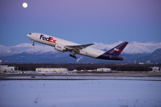 Boeing 777-200 (N682FD) - Mid-January 2013 at the outer perimeter roadway.  Zero degrees and winds at 20-30mph.