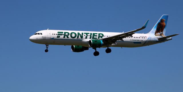 Airbus A321 (N723FR) - On final is this 2018 Frontier Airlines Airbus 321-211 with "Gordon" the Golden Eagle pondering a tail view from the Spring of 2021. 