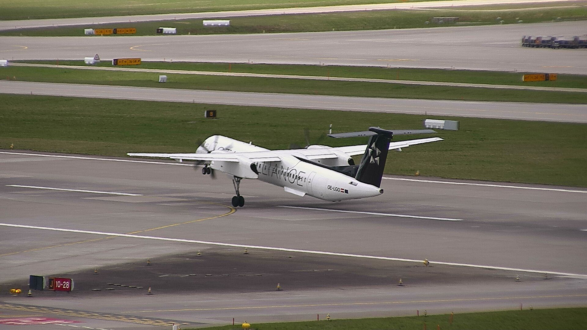 de Havilland Dash 8-100 (OE-LGO) - Steep departure out of Zurich to Geneva as flight #2824. That tail looks close...