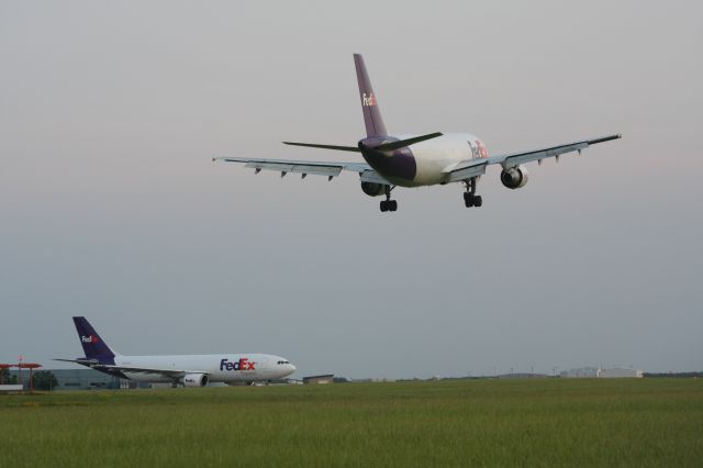 Airbus A300F4-600 (N869FE) - Departing A-306 awaits landing company traffic at Outagamie County Airport.