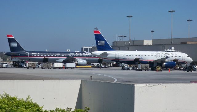 Airbus A320 (N652AW) - US A320-232 N652AW in the final US livery with company A321 N162UW in the 1997 livery at LAX on Sept 5, 2009.