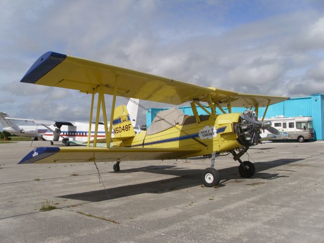 Piper Cherokee (N5048F) - Holy Smoke AG Cat Biplane. I understand this airplane is used for doing ariel pictures in smoke. Smiley faces and messages.