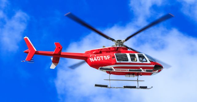 Bell 407 (N407SF) - Chopper N407SF passing over the airfield at TNCM ST Maarten.