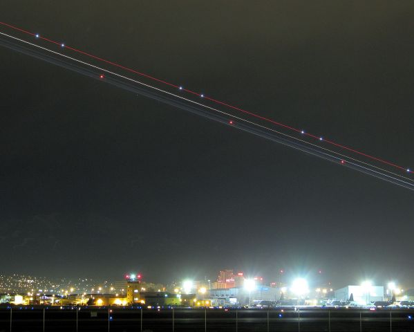 KRNO — - The navigation lights of a United Airlines Airbus climbing away from Reho Tahoe Internationals runway 16R appear as streaks in the predawn sky as the flight departs.  The RNO control tower seen on the bottom just to the left of center will be closed later this year when the new tower is completed.  The bright lights along the bottom right are illuminating the Nevada ANG "High Rollers" aircraft ramp.