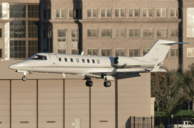 Learjet 45 (N800AB) - Just a moment from setting down onto 35R in Centennial, Colorado with a setting sun providing the illumination.