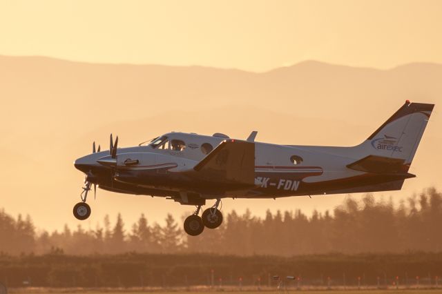 Beechcraft King Air 90 (ZK-FDN) - The local Flying Doctor Beech King Air C90 getting airborne off Runway 20 into the setting sun.