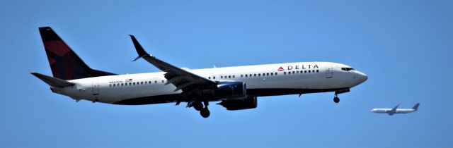 Boeing 737-900 (N18706DZ) - MCO-SEA in the background is DAL 196 from ICN getting in line to land. 6-30-22