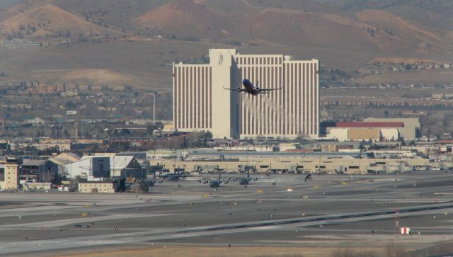 Boeing 737-700 (KRNO) - Long range shot (from mountains a few miles away) of Reno Tahoe International Airport as a SWA flight climbs away from runway 16R.