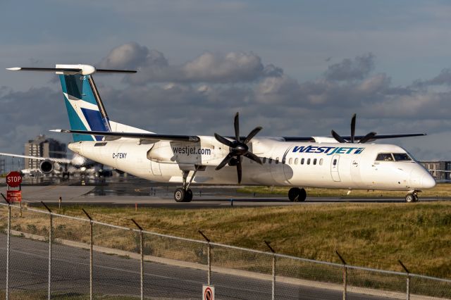 de Havilland Dash 8-400 (C-FENY) - 18th July, 2022: WestJet Bombardier Dash-8-Q400 taxiing for departure from runway 06R at Toronto's Pearson International. 