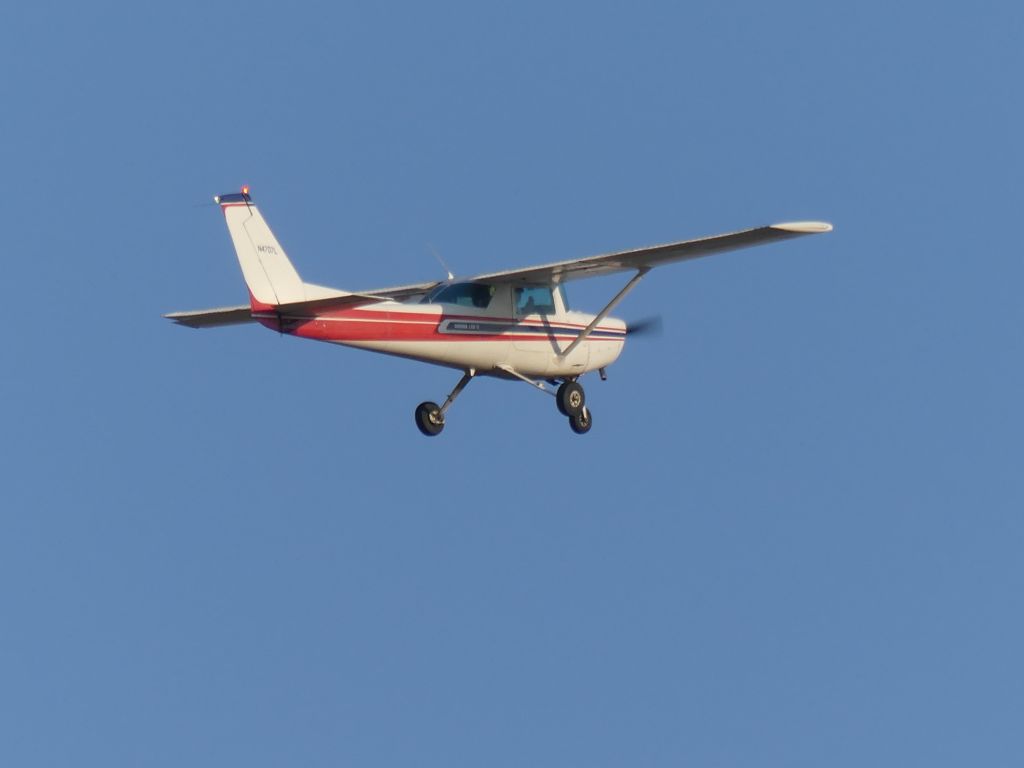 Cessna 152 (N4707L) - A local flight school Cessna 152 training flight at 7 pm on a summer evening. Doing touch and goes on runway 20 at Sacramento Executive Airport. Serial number 15284222. Taken from the south hangars. 7/29/24