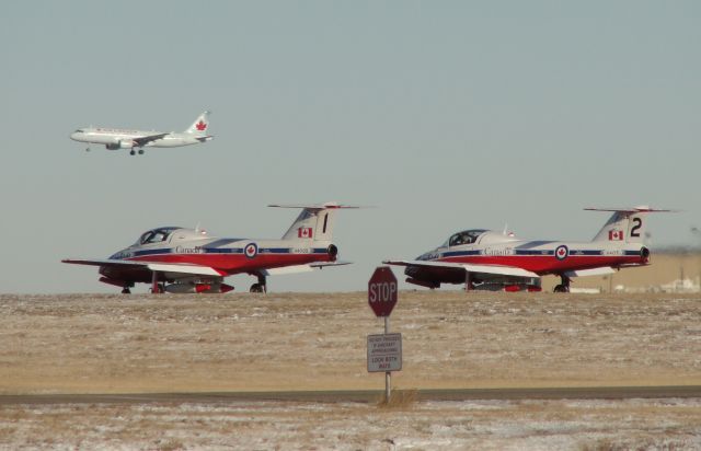 — — - Number One and Two Snowbirds hold on Runway 34 while Air Canada lands on Runway 28.