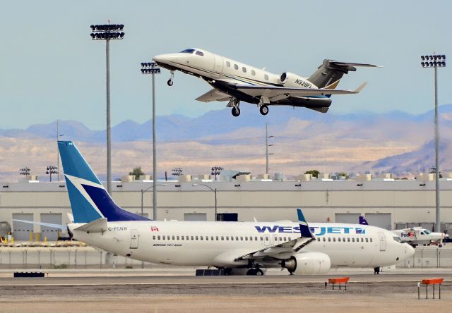 Embraer Phenom 300 (N328FL) - N328FL Embraer 505 Phenom 300 CN: 50500097 - C-FCNW Westjet Boeing 737-8CT - cn 39092 / ln 3580br /br /McCarran International Airport (KLAS)br /Las Vegas, Nevadabr /TDelCorobr /September 12, 2013