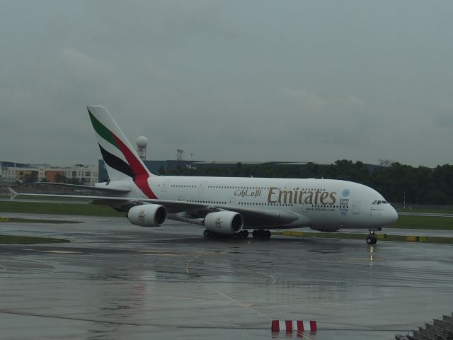 Airbus A380-800 — - A380 taxying to stand Changi dull & wet. From departures.