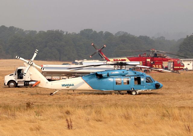 Sikorsky S-70 (N940AA) - Shasta Lake,CA LZ off airport Helicopter Base Camp for the Carr/Hirz/Gorge Fires burning between Lakehead and Red Bluff CA. Red Bluff, CA PJ helicopters in contract colors for PGandE- Pacific Gas and Electric Co at base during the early AM flight pre-checks. This is said to be one of 2 UH-60A "Utility Hawks" for PGandE flown by PJs. I did not get to see this -60A fly -as it was here for the last 5 days. Sillers S-64E Skycrane departed for the Gorge Fire in Red Bluff about 30 mins after I took these photos. I posted the Skycrane video lifting on my Youtube page. Click full. 8/19/2018.