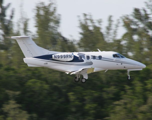 Embraer Phenom 100 (N999RN) - An Embraer Phenom 100 landing at Naples, Florida.  Photo by Erick Stamm.