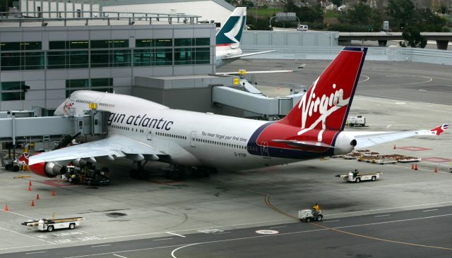 Boeing 747-400 (G-VTOP) - KSFO - VTOP being readied for push back from the Intl dock in a race against British Airways( out of view and ready for push back too) to see who can be 1st for departure. Jan 2005.