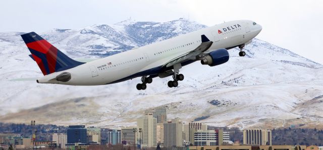 Airbus A330-200 (N861NW) - Deltas N861NW, an A332, is on the rise off RNOs 34L enroute to Alaska. The US Marines seated on the port side had a great view of downtown Reno as the big Bus was climbing out. The departure was delayed for a short time so some green anti-ice fluid could be sprayed on the wings. (If my memory serves me correctly, I think FA member Sam K. once related that the green colored mixture is called "Type IV Anti Ice" while the red mixture is "Type I De-Ice". The green mix used on this DAL fleetbirds wings can be seen ... slightly ... on the port wing and the reflection of the green color from the starboard wing can be seen on the fuselage.)