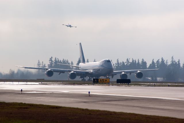 Boeing 747-200 (N747EX) - First lift-off. Note T-33 chase plane on left wing