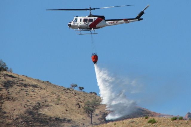 N987SF — - This first photo of N987SF in the FA photo gallery shows "Helitack 403," the (NDF) Nevada Division of Forestrys Bell UH-1H Iroquois, making a water drop on the west edge of the "Brooklyn Fire" located on the south side of Peavine Mountain on Sunday, July 17, 2011.  Three air tankers and this helo, along with 125 firemen on the ground, jumped on the fire and reined it in just a few hours before strong wings moved in to the area.