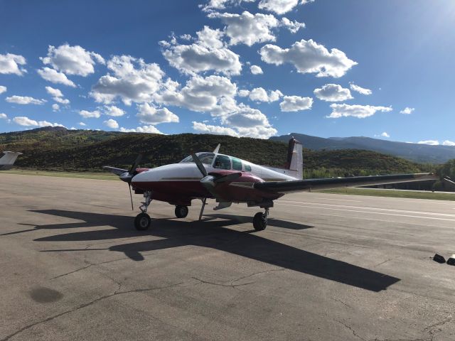 Beechcraft Twin Bonanza (N773AG) - N773AG a 1960 Supercharged Twin Bonanza on the ramp in Aspen