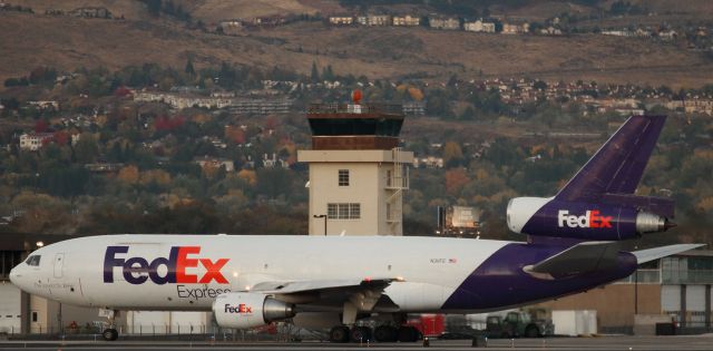 McDonnell Douglas DC-10 (N311FE) - FDXs MD-10 "Sherrese" (N311FE) passes Reno Tahoe Internationals old control tower while taxiing south toward runway 34L in the final few moments before sunrise.  Just minutes after this snap was taken, RNOs runway lighting was turned off and the morning suns rays illuminated the trees in the background creating an excellent autumn scene, but Sherrese had already departed for Memphis.