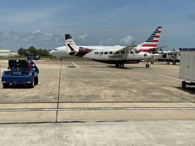 Cessna Caravan (V3-HHI) - Tropic Air Grand Caravan 208 taking a shortcut  around an American 737-800 to it parking spot at BZE 4/9/21