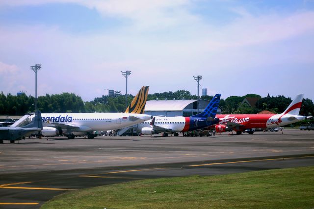 Boeing 737-500 (PK-CLL) - The tails line up at Ngurah Rai International Airport in Denpasar, Bali, Indonesia.  Sriwijaya Air's Boeing 737-524 is seen in the middle.  28th March, 2014.