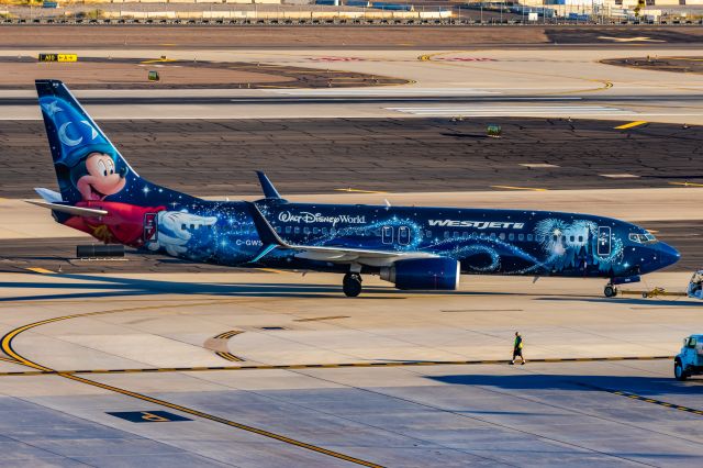 Boeing 737-800 (C-GWSZ) - WestJet 737-800 in Sorcerer Mickey special livery taxiing at PHX on 11/13/22. Taken on a Canon R7 and Tamron 70-200 G2 lens.