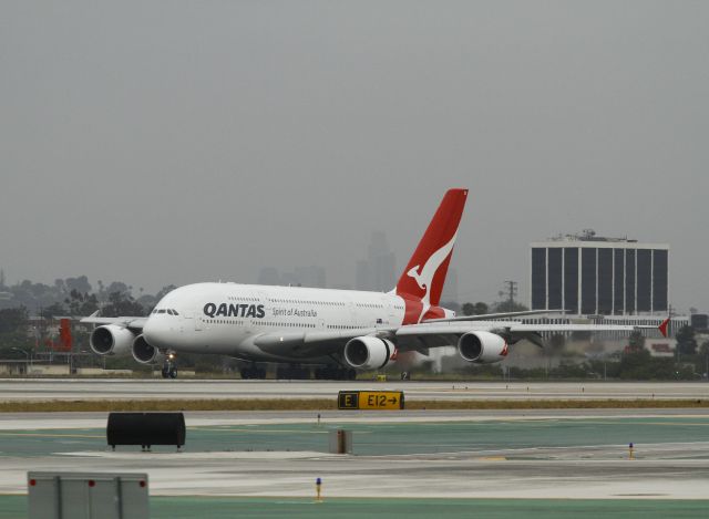 Airbus A380-800 (VH-OQK) - This A380 is named John Robertson Duigan. He is a pioneer aviator who built and flew the first Australian made aircraft on 16 July 1910. This A380 is making an early morning landing on runway 24R, Los Angeles International Airport. Downtown Los Angeles, seen as dark shadows behind the aircraft is about 15 miles away. The nose wheels are just touching down, wing spoilers are deployed and the thrust reversers on the inboard engines are open.