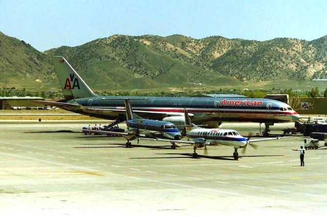 Boeing 757-200 (N612AA) - KRNO - American Airlines 757 on the ramp and sharing space with 2 twin commuters on a nice summer day in Reno. This 757-2 is long gone, scrapped in Roswell in 2014. cn: 24488 ln: 240. photo date apprx Aug 1999.