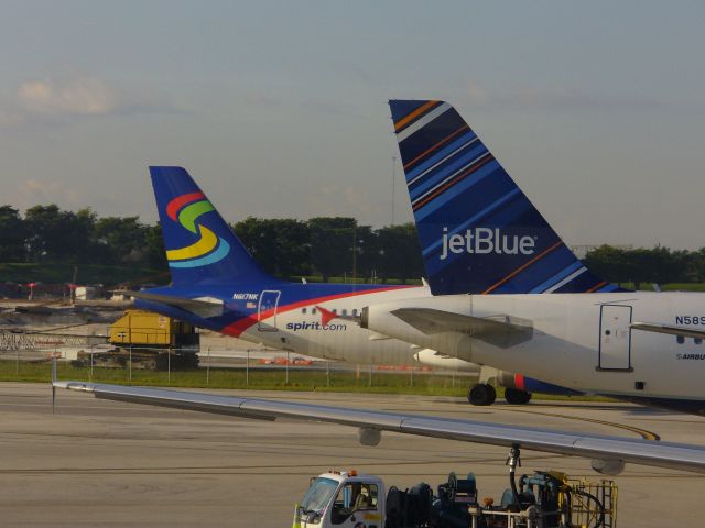 Airbus A320 — - Two A320s, one in new Spirit Airlines livery and the other wearing jetBlue Barcode.