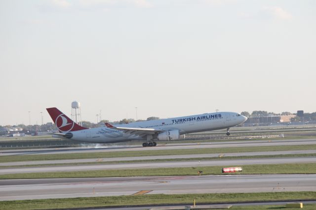 Airbus A330-300 (TC-JNI) - 102513 tires smoking and thrust reversers actuating. landing on the newly opened Rwy 28C