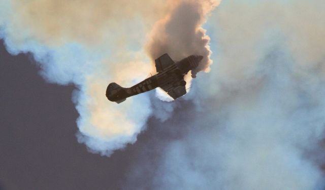 YAKOVLEV Yak-52 (VH-YRO) - Immersed in his own smoke during airshow routine - I enjoyed the effect of the sun behind the plane and smoke and the shadows it created